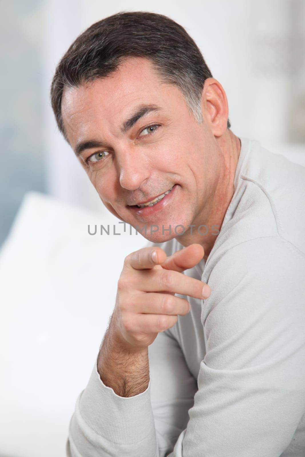 Closeup of handsome man pointing at camera