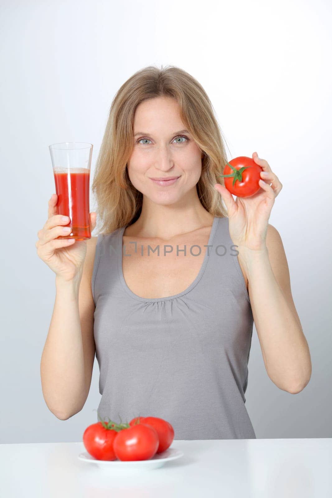 Woman drinking tomato juice