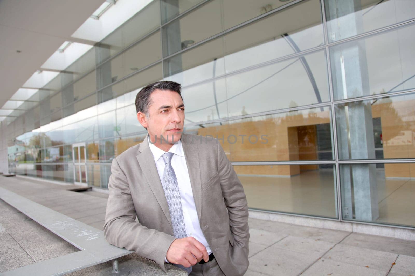 Businessman standing outside modern building
