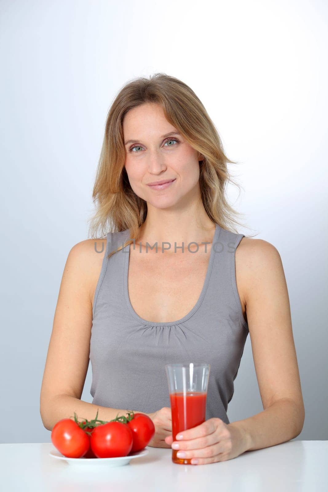 Woman drinking tomato juice
