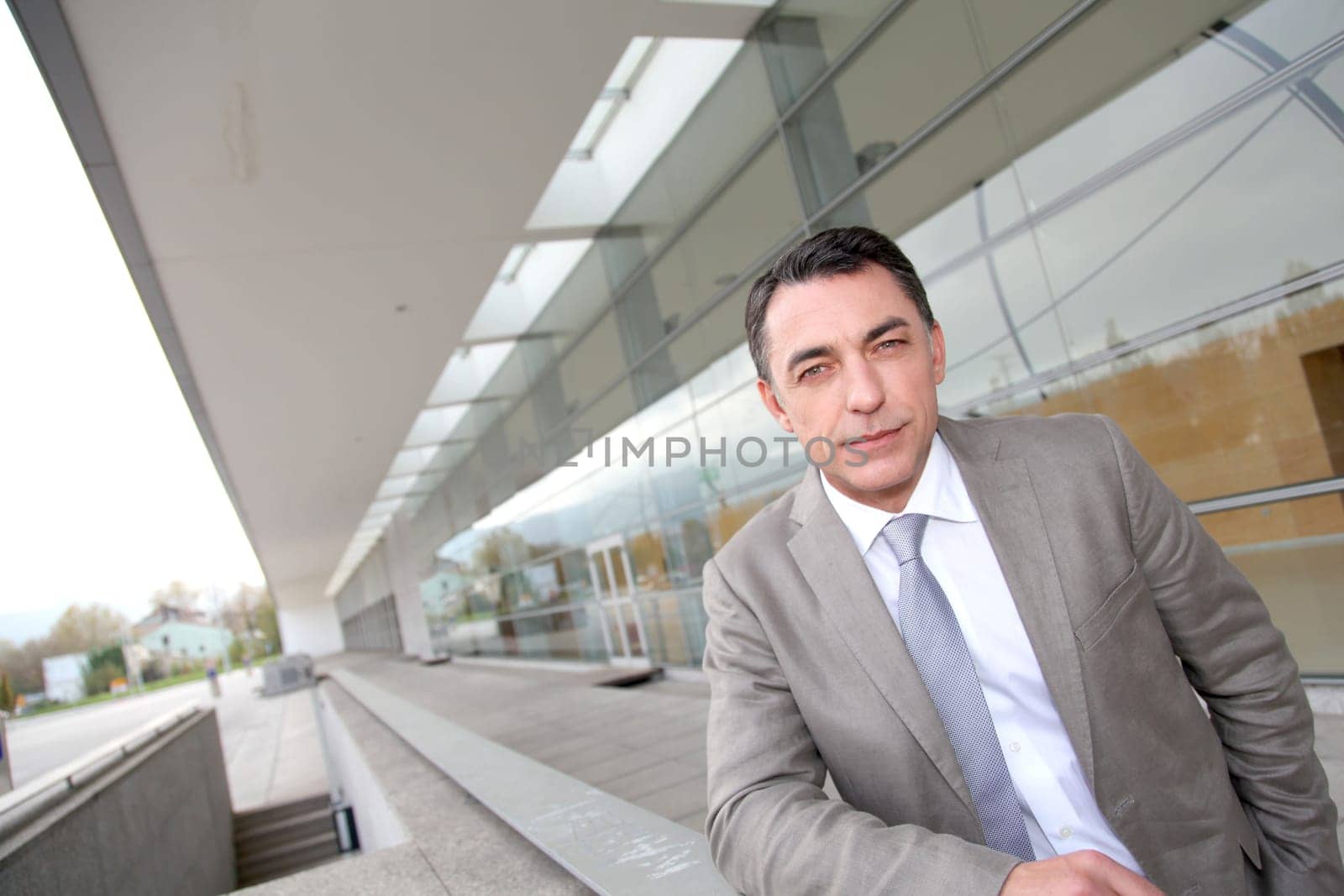 Businessman standing outside modern building