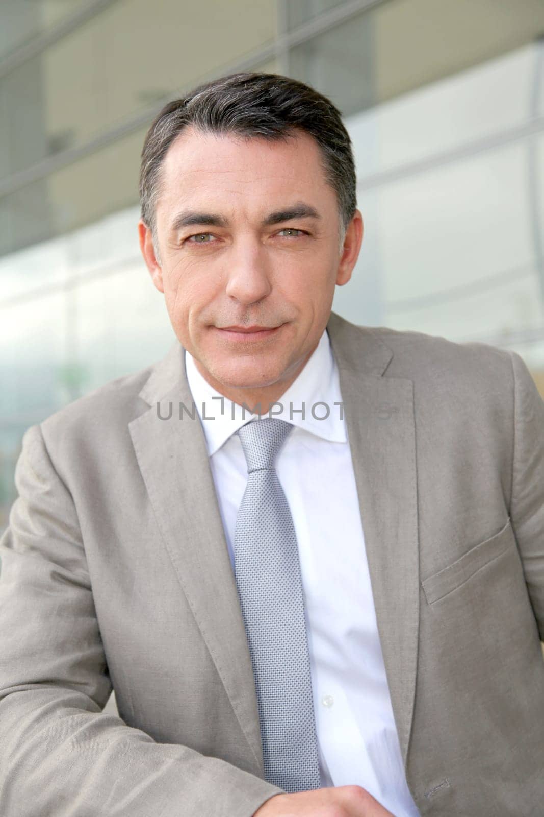 Businessman standing outside modern building