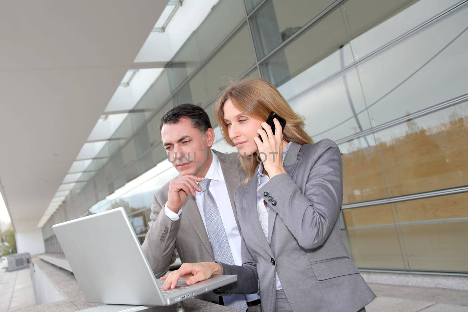 Sales people working outside modern building