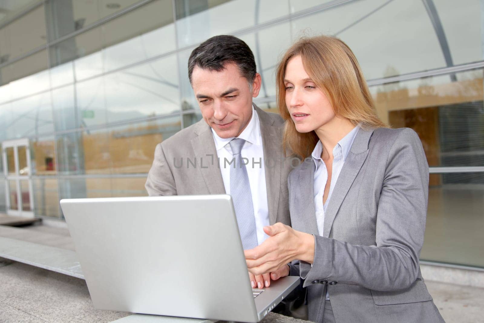 Sales people working outside modern building