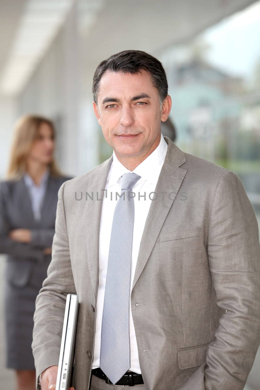 Businessman standing outside modern building