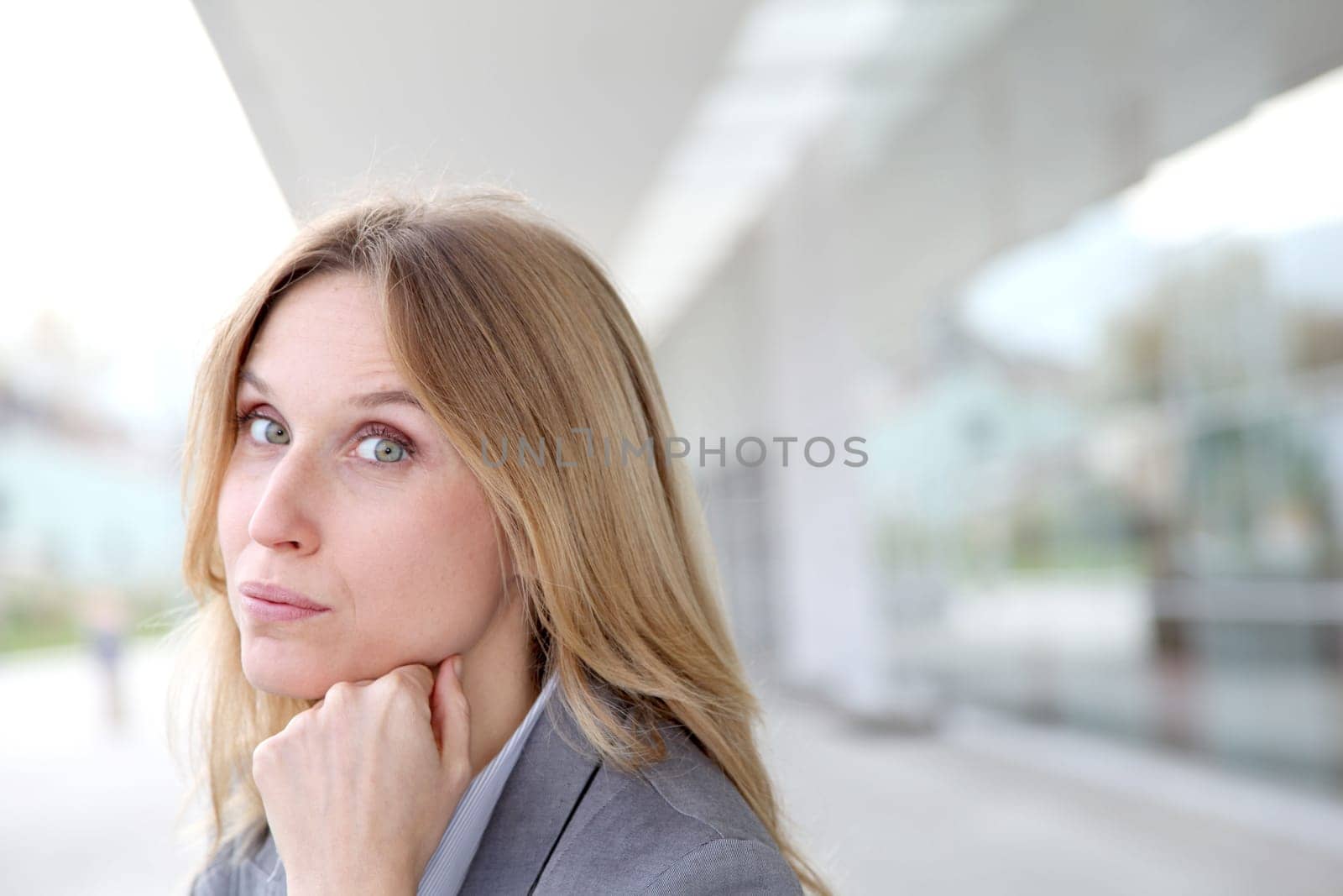 Closeup of blond businesswoman standing outside