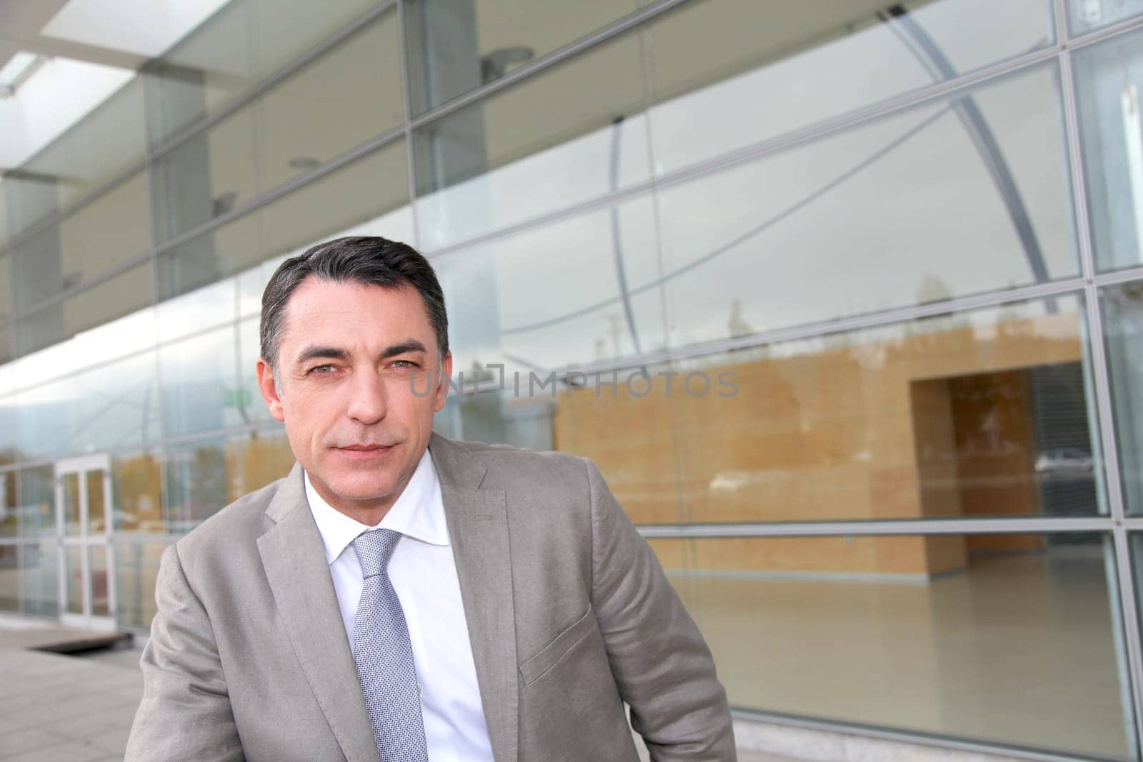 Businessman standing outside modern building