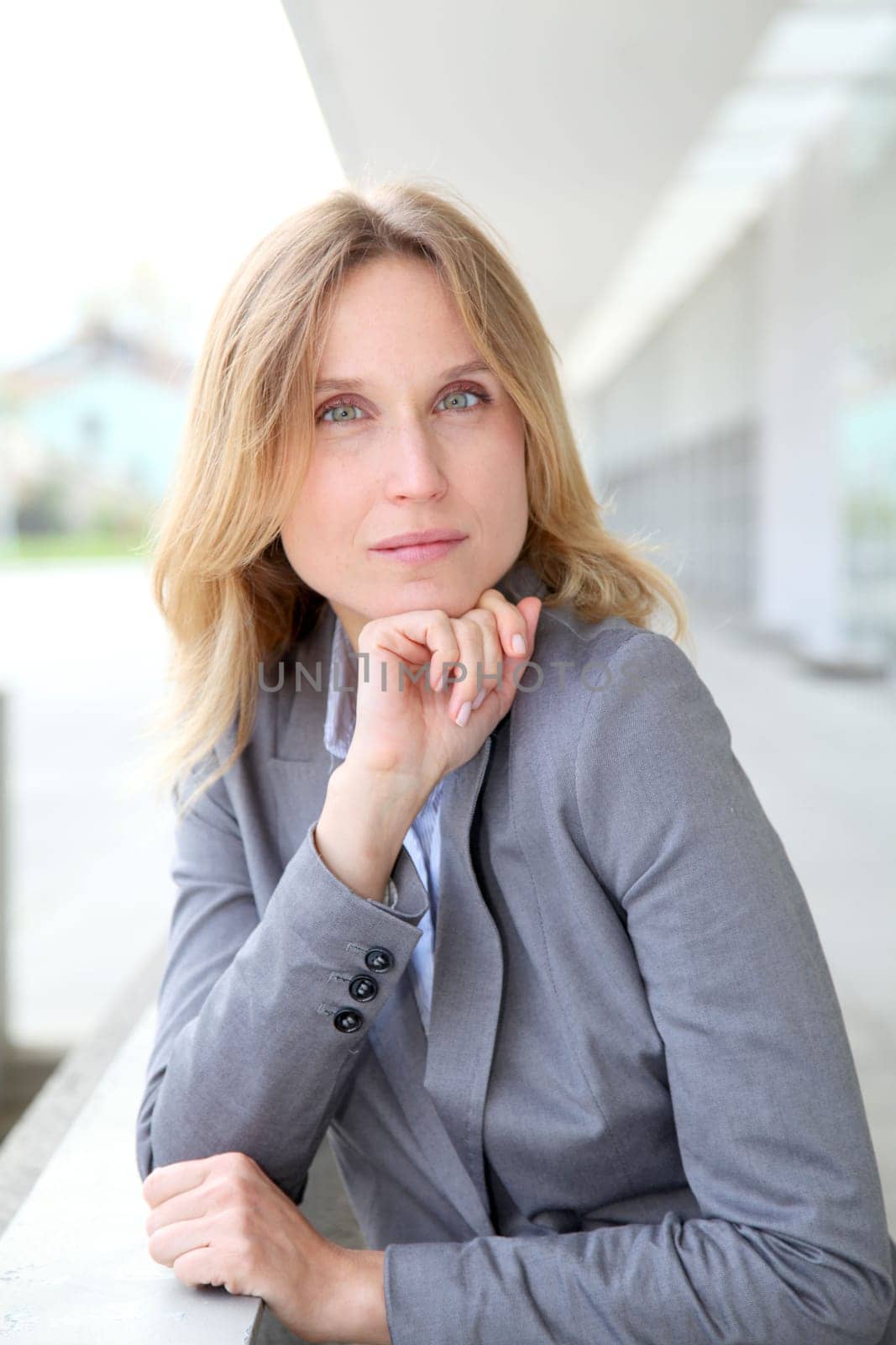 Closeup of blond businesswoman standing outside