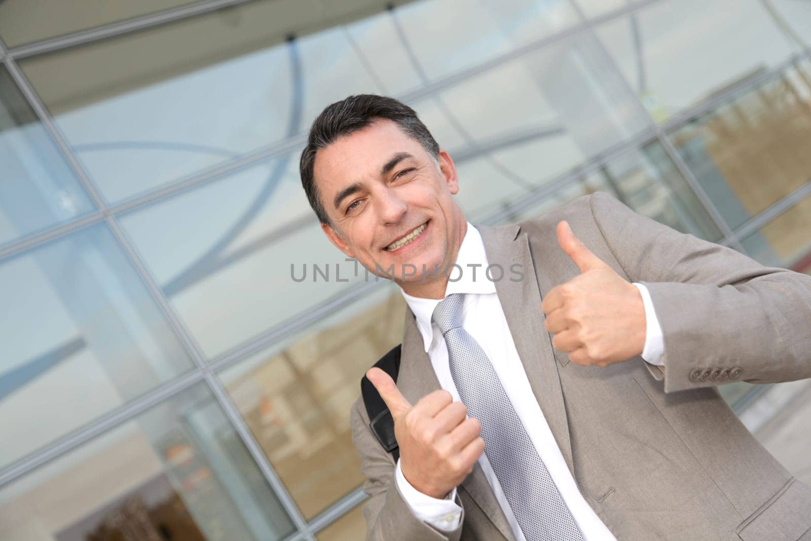 Businessman standing outside modern building
