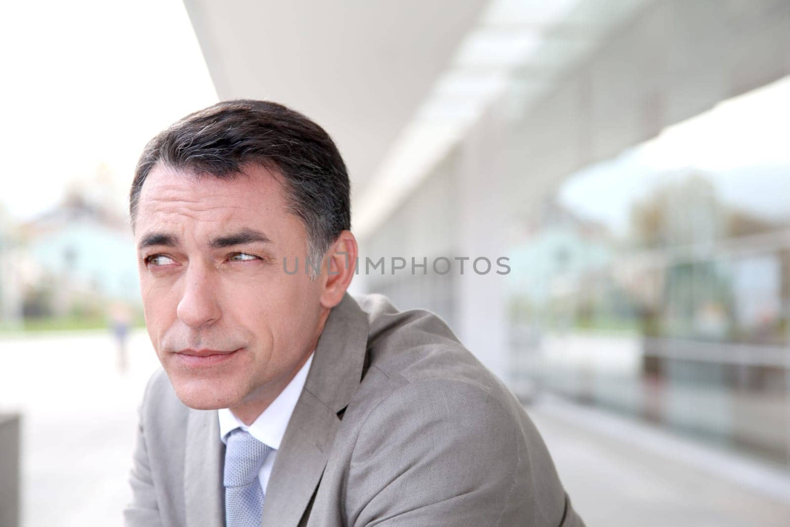 Businessman standing outside modern building