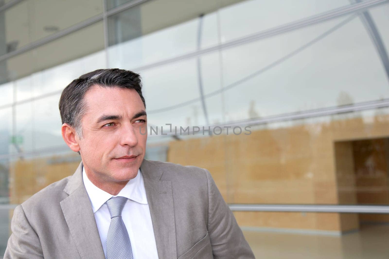 Businessman standing outside modern building