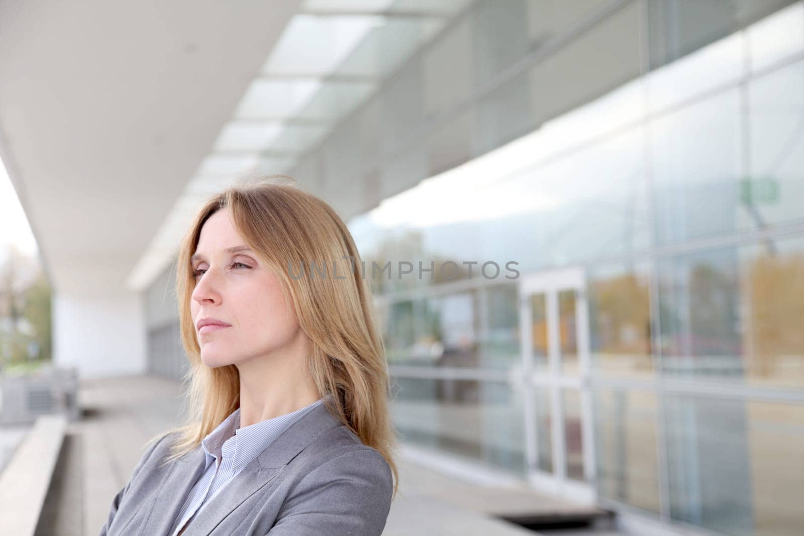 Closeup of blond businesswoman standing outside