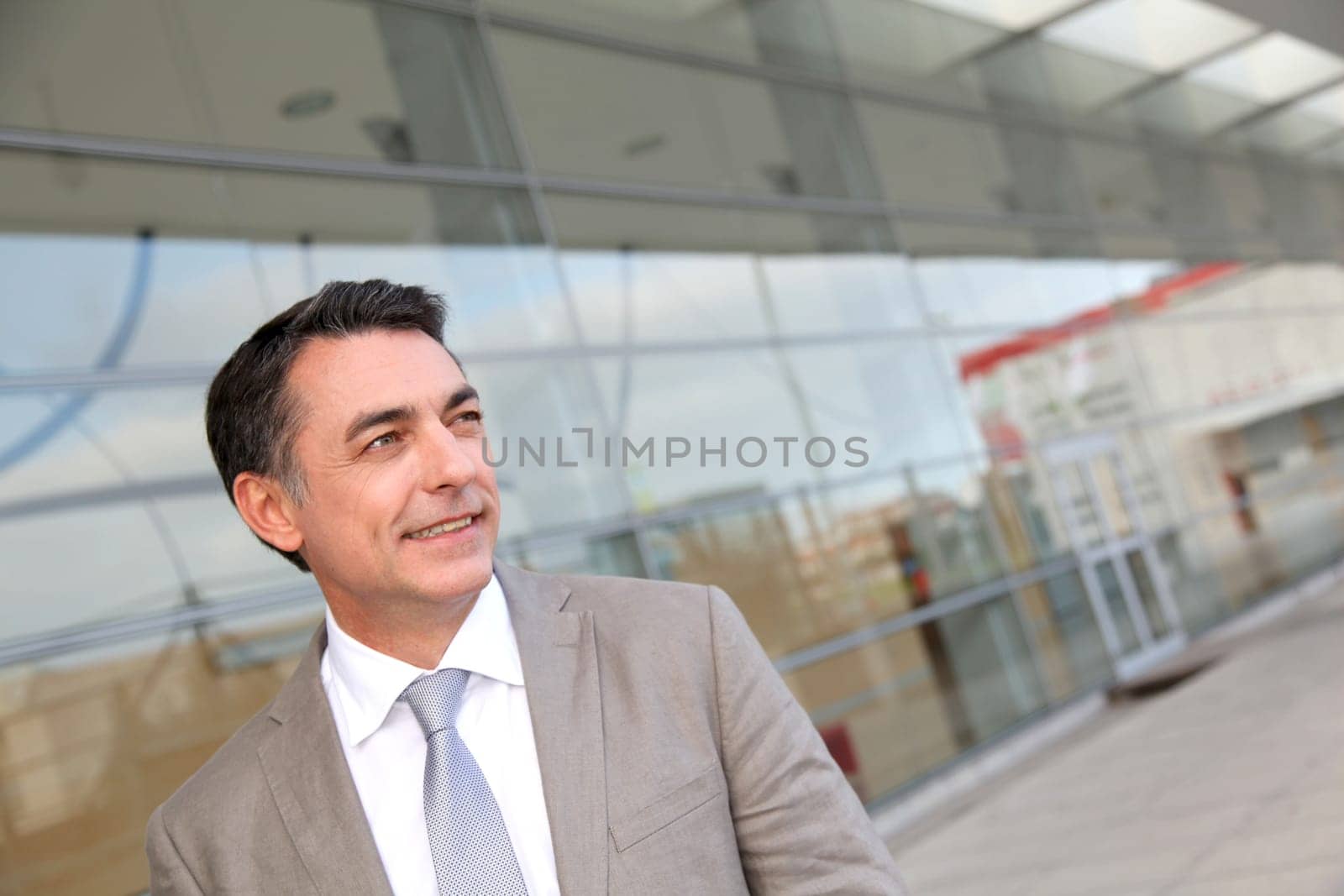 Businessman standing outside modern building