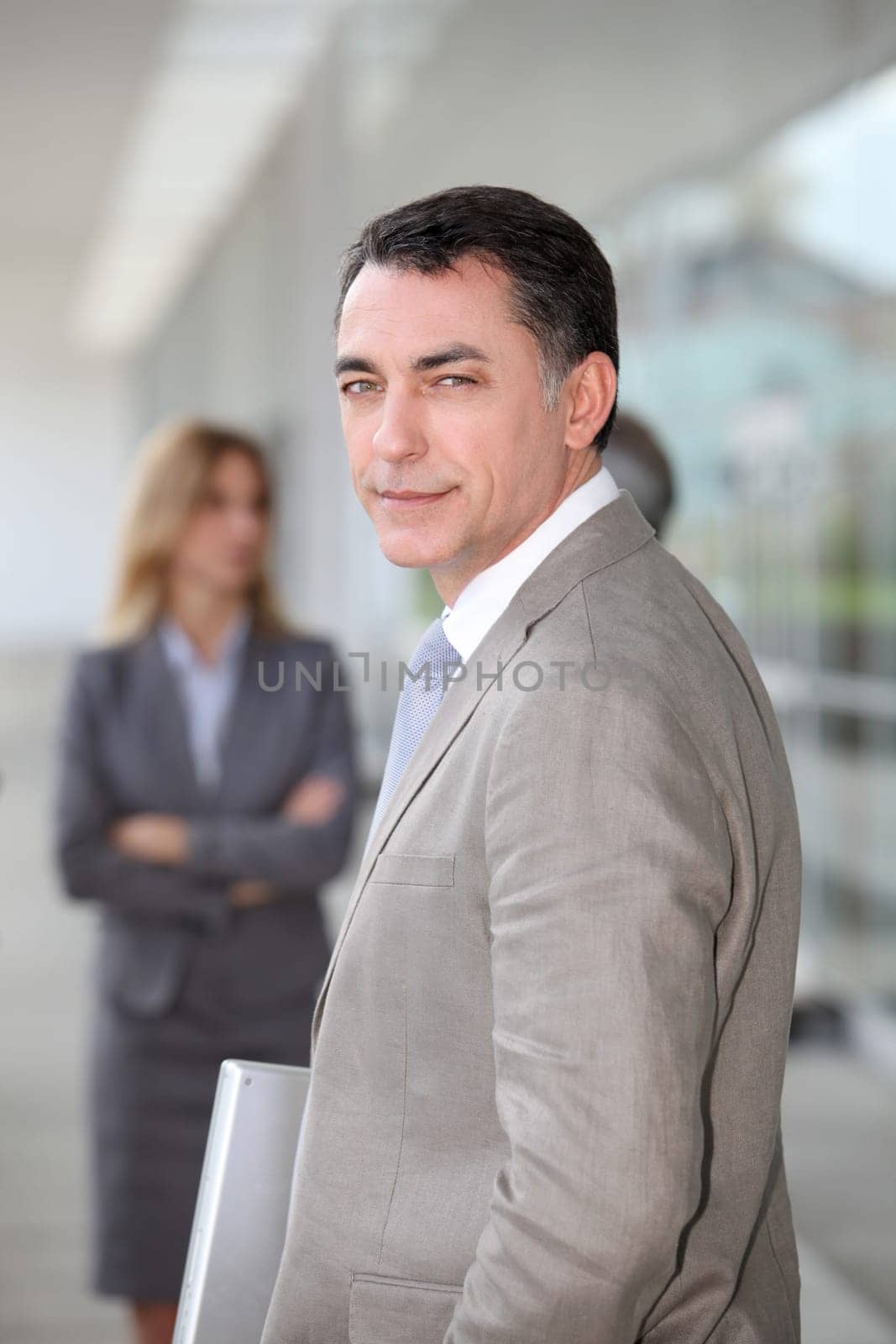 Businessman standing outside modern building
