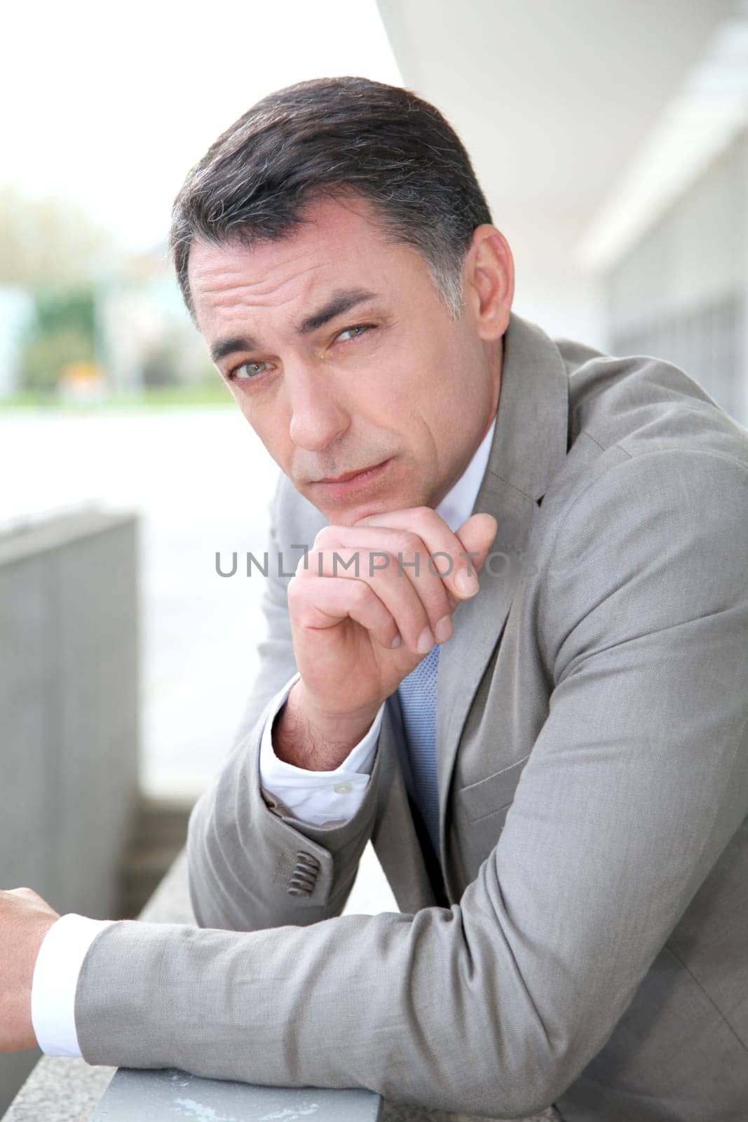 Businessman standing outside modern building
