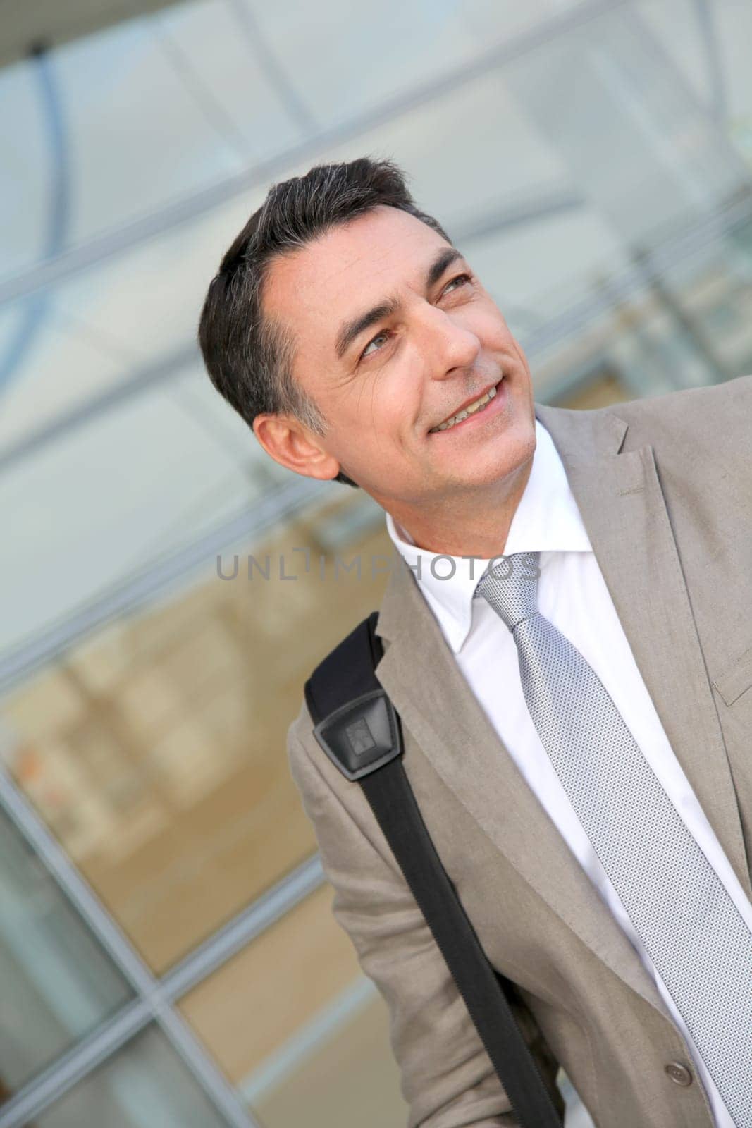 Businessman standing outside modern building