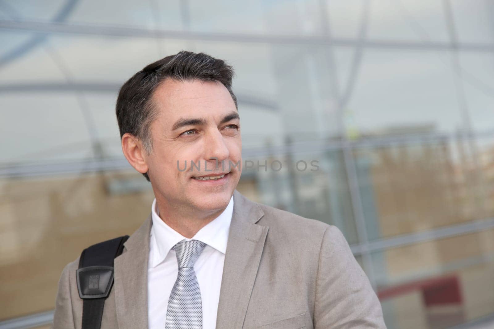 Businessman standing outside modern building