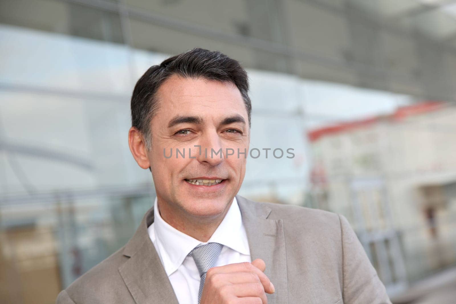 Businessman standing outside modern building