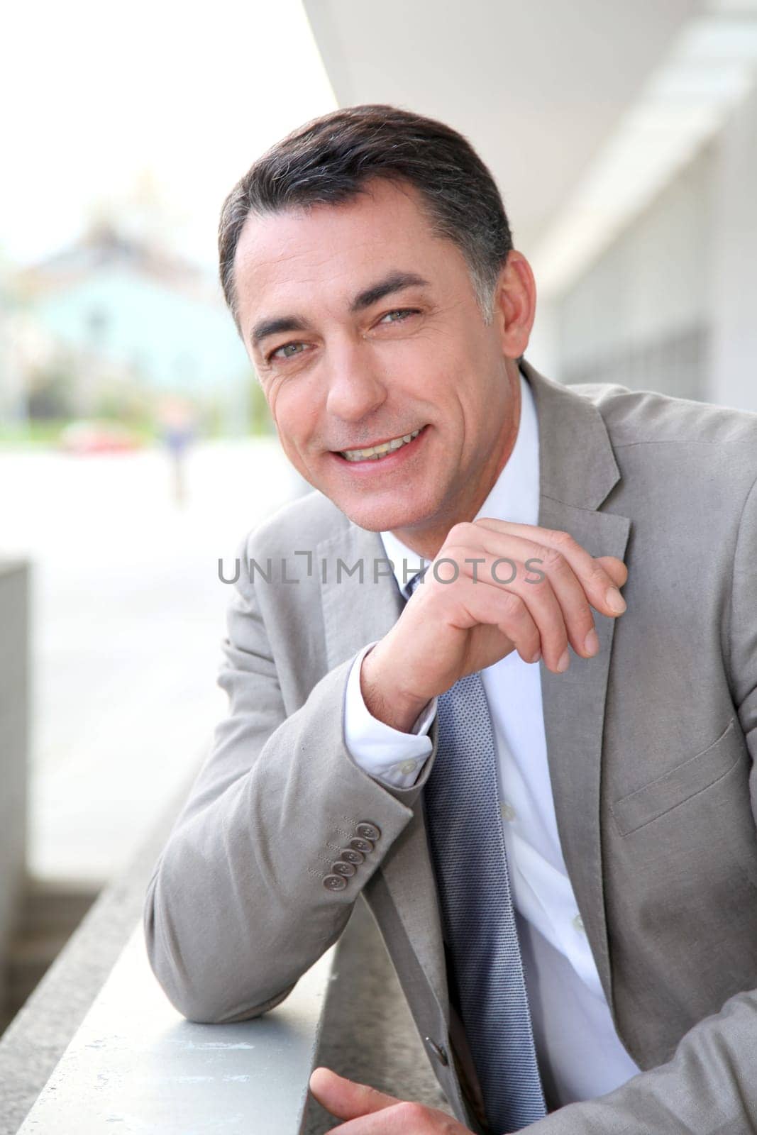 Businessman standing outside modern building