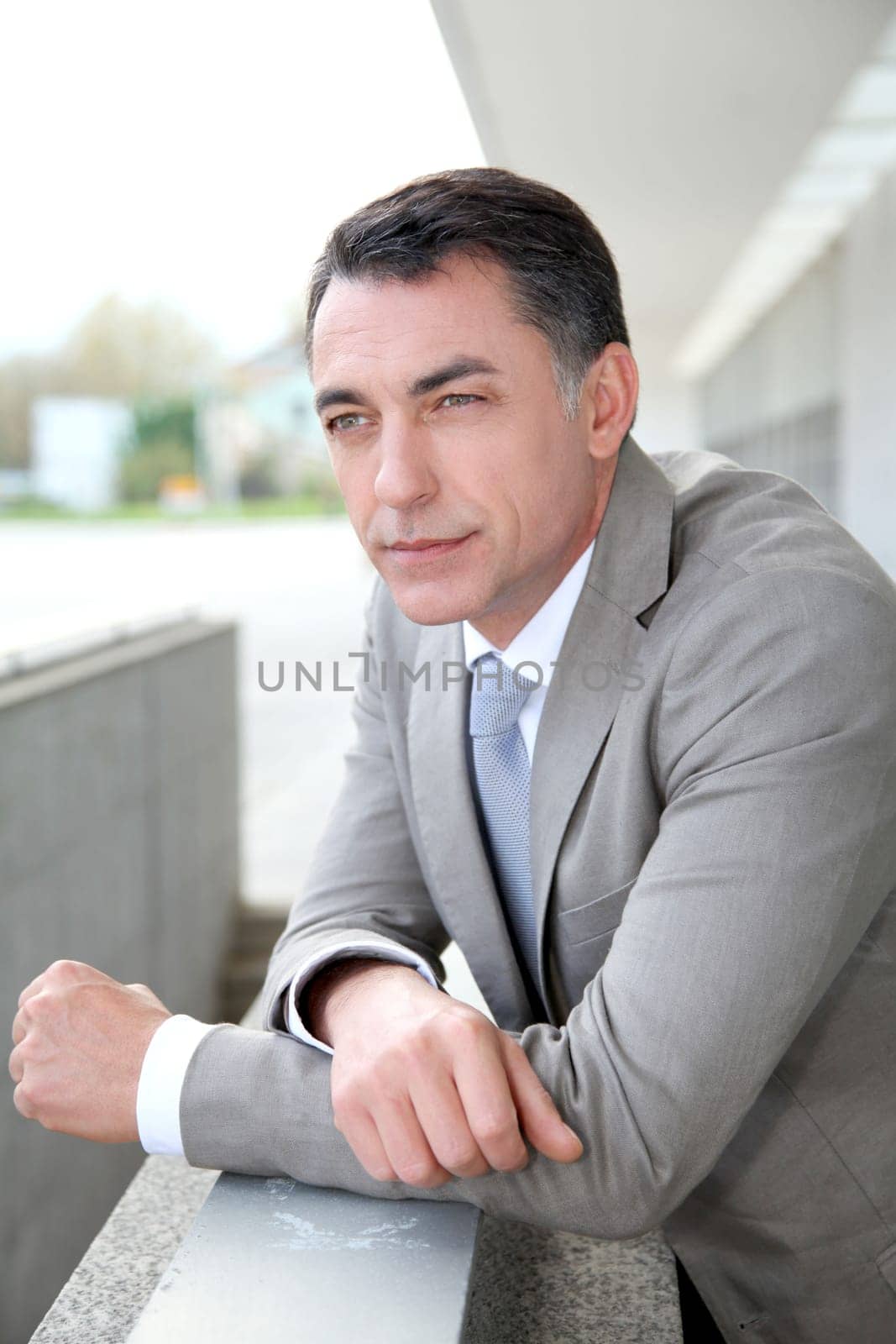 Businessman standing outside modern building