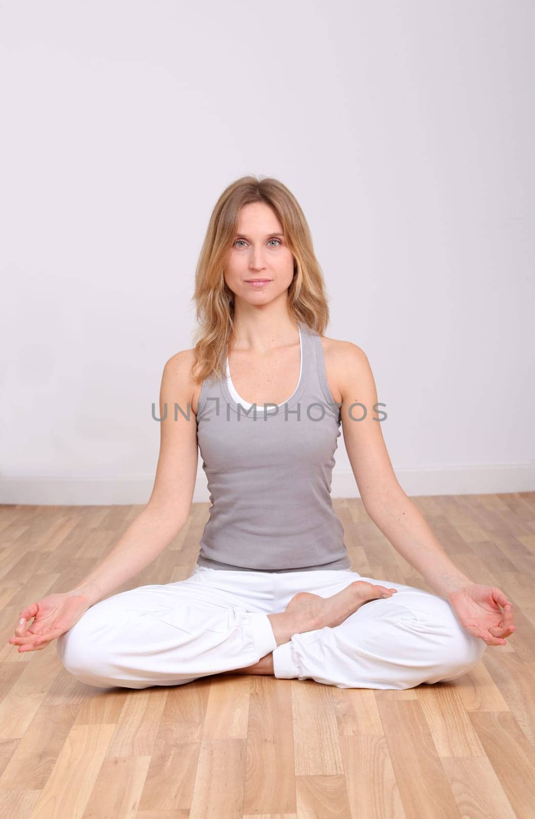 Blond woman doing yoga exercises