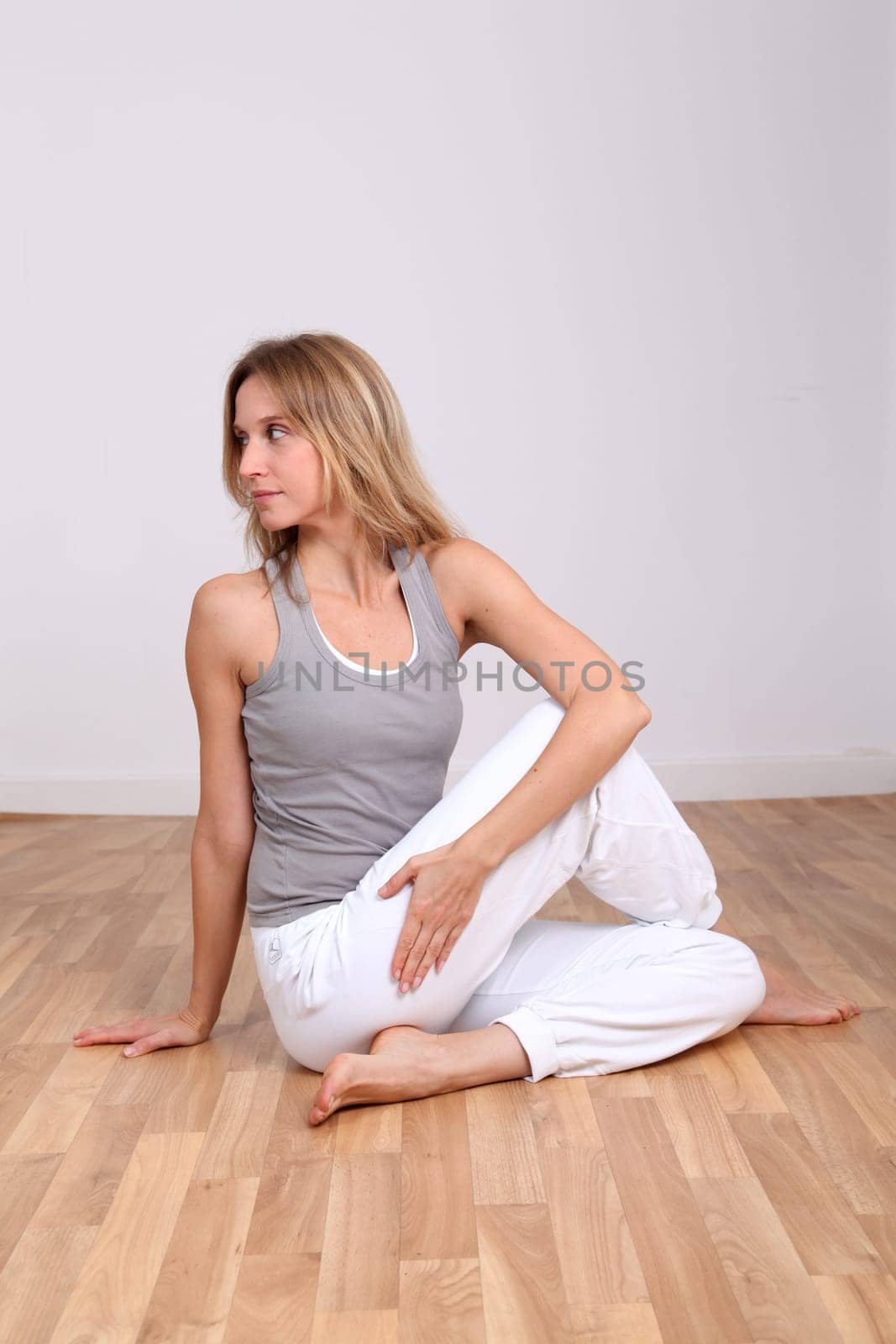 Blond woman doing yoga exercises