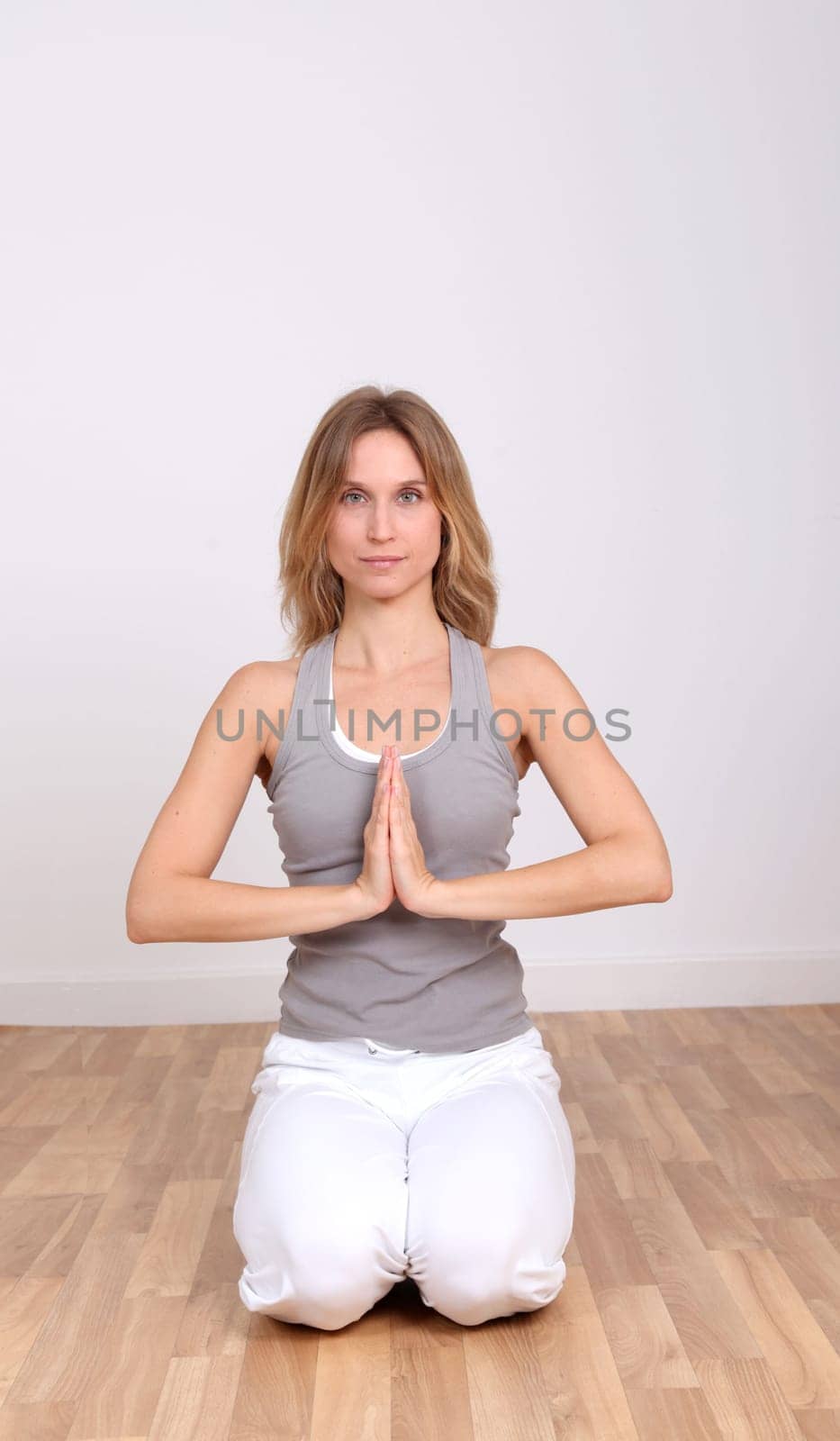 Blond woman doing yoga exercises