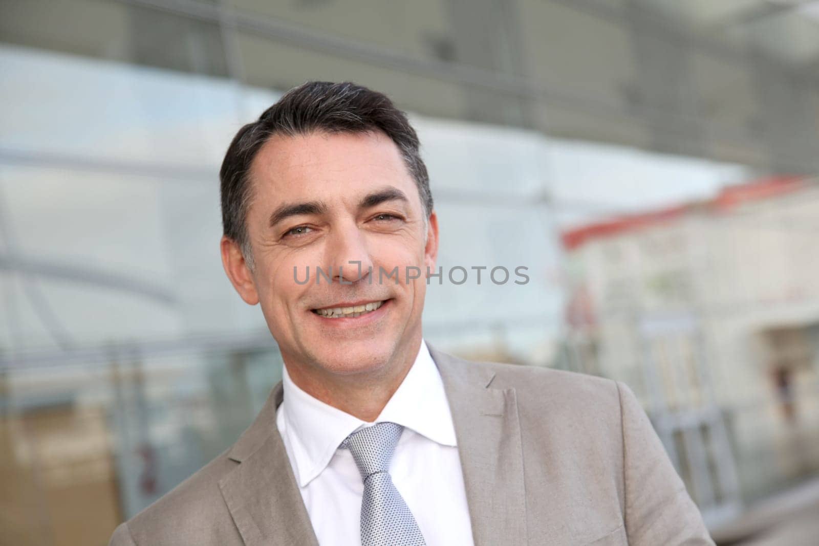 Businessman standing outside modern building