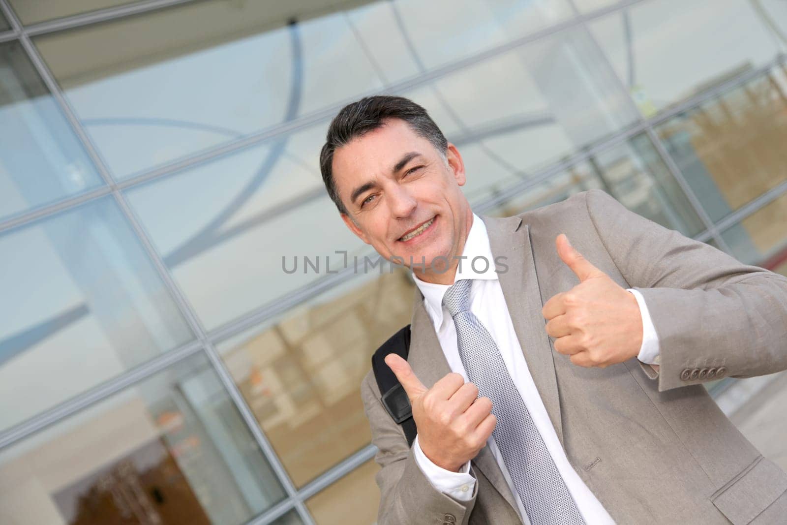 Businessman standing outside modern building