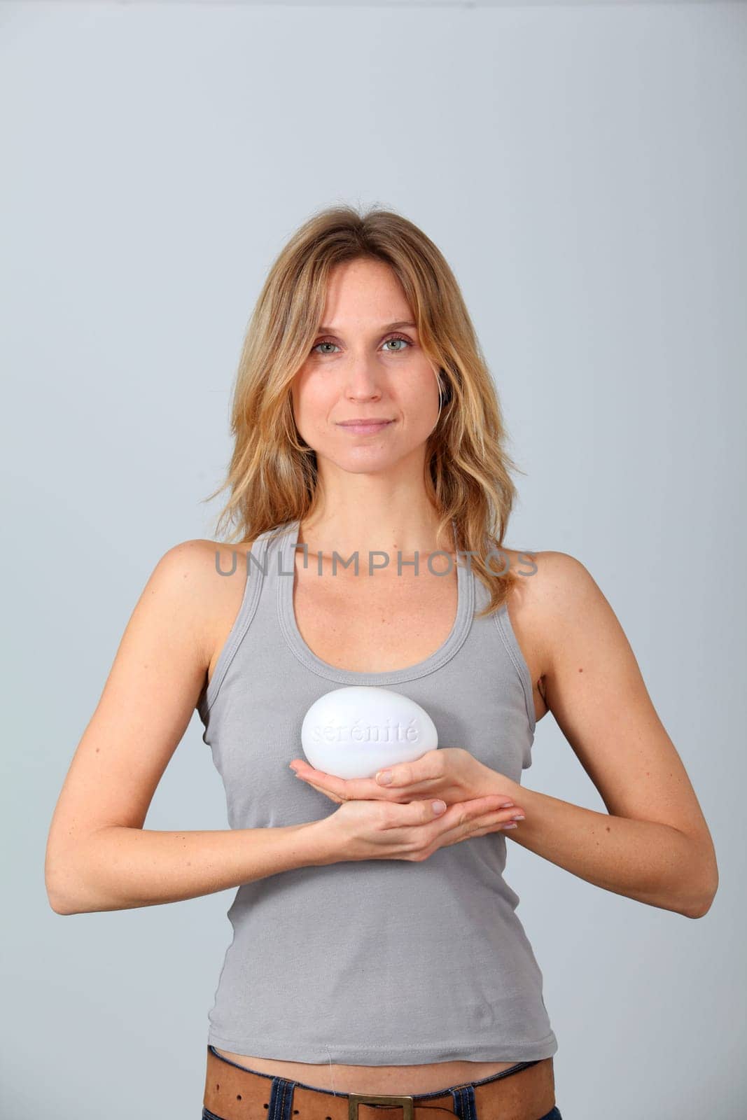 Woman holding stone with message