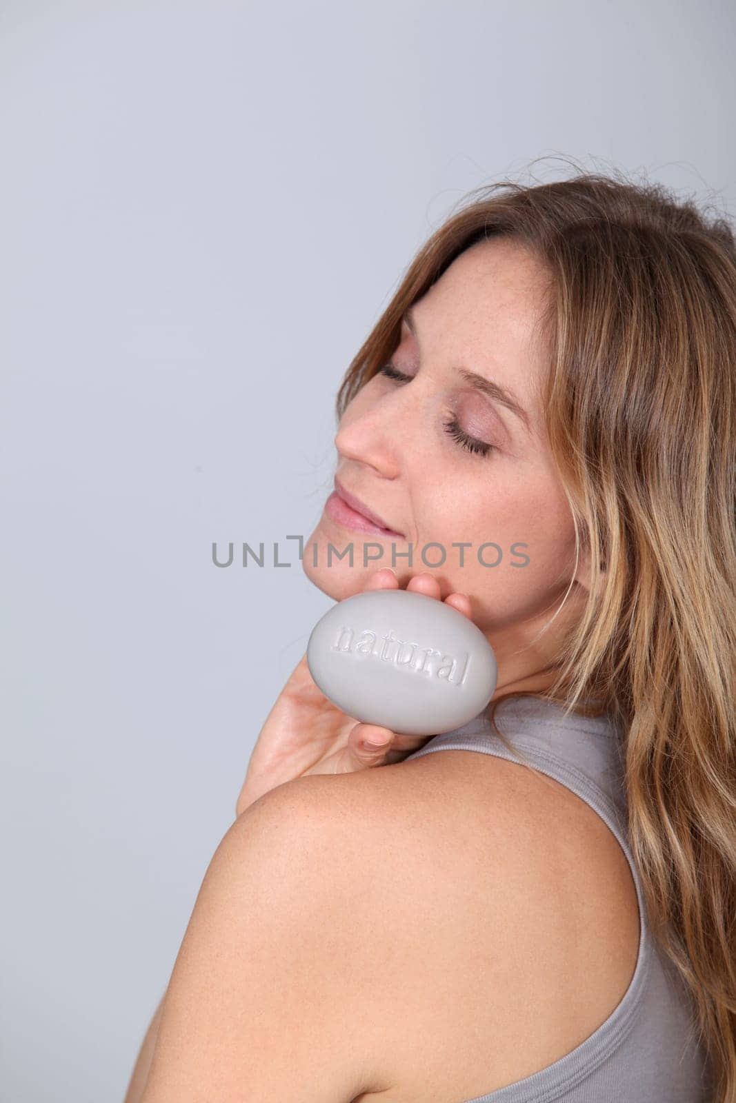 Woman holding stone with message