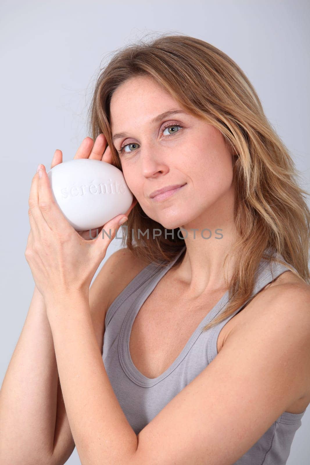 Woman holding stone with message