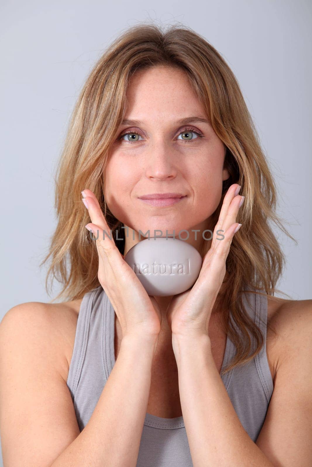 Woman holding stone with message