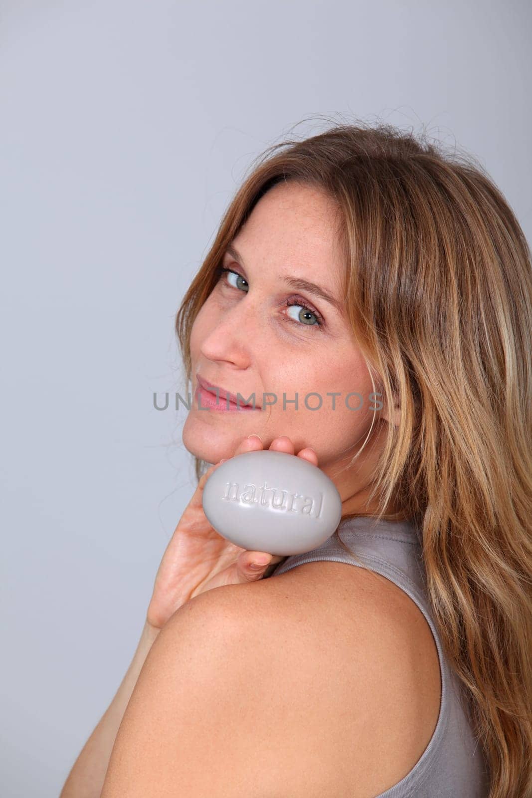 Woman holding stone with message