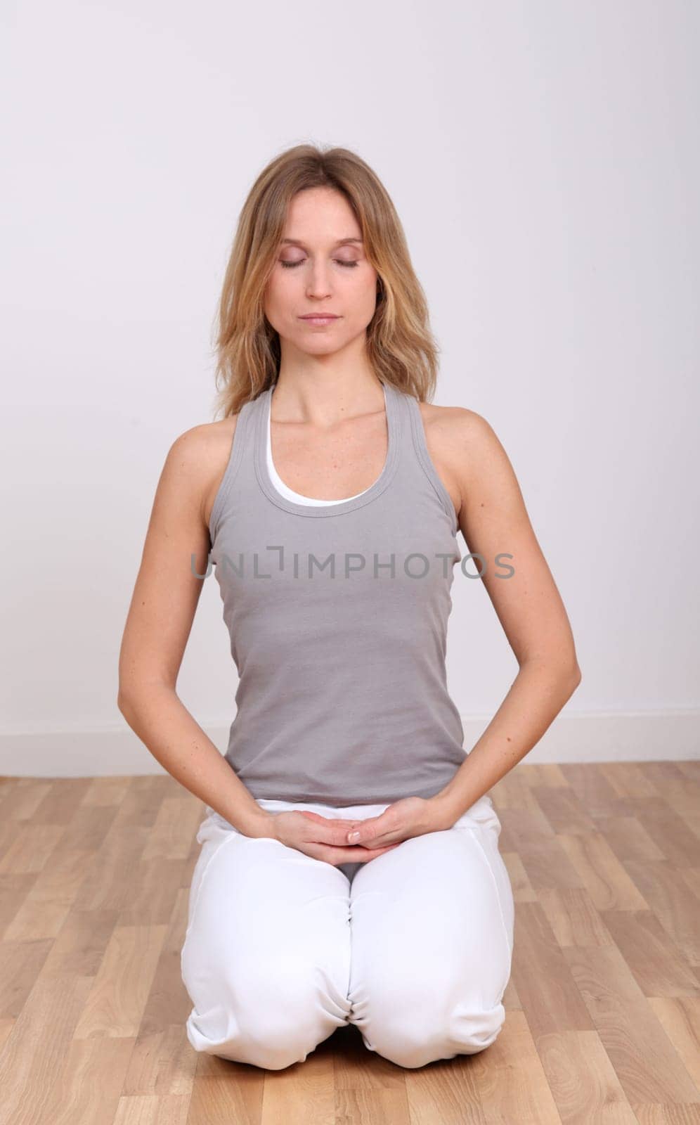 Blond woman doing yoga exercises