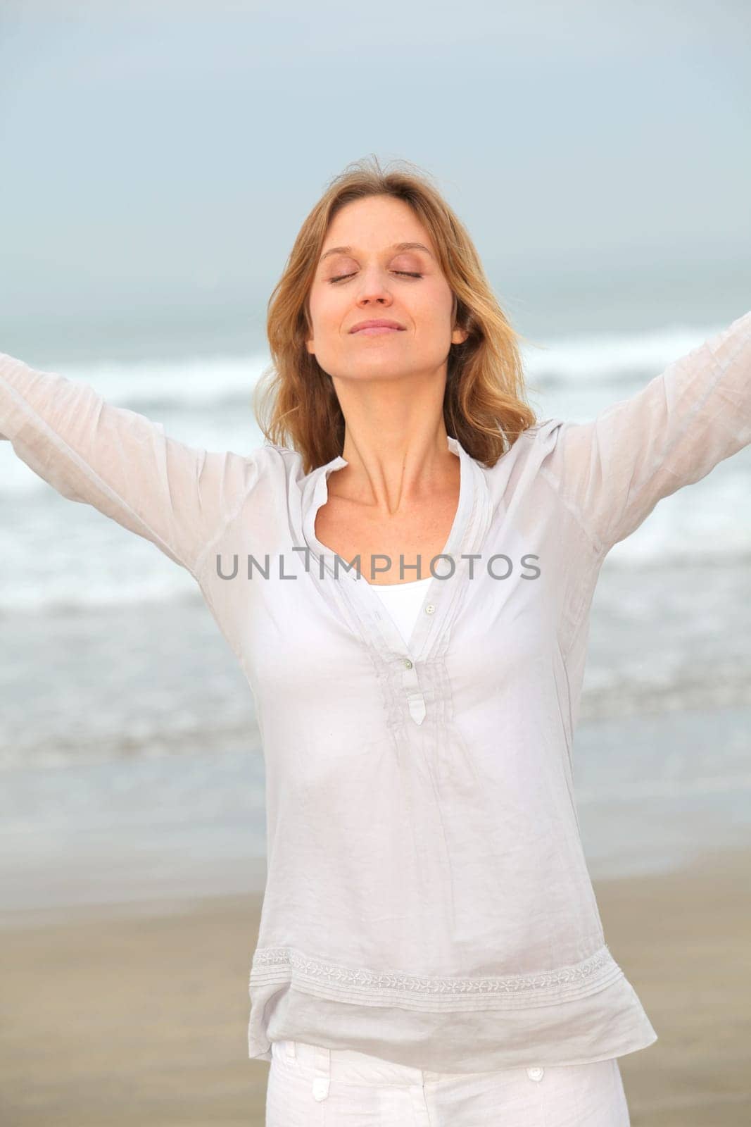 Woman breathing fresh air by the sea