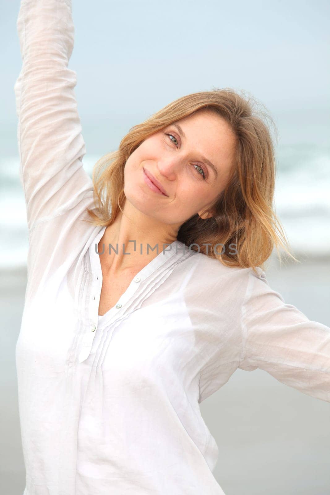 Woman breathing fresh air by the sea