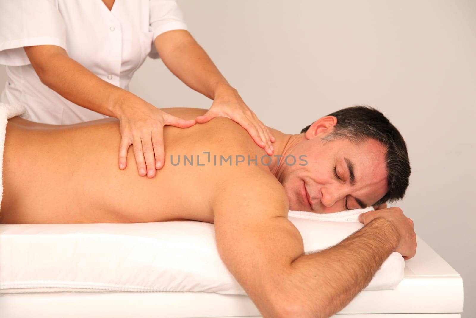 Man laying on massage bed