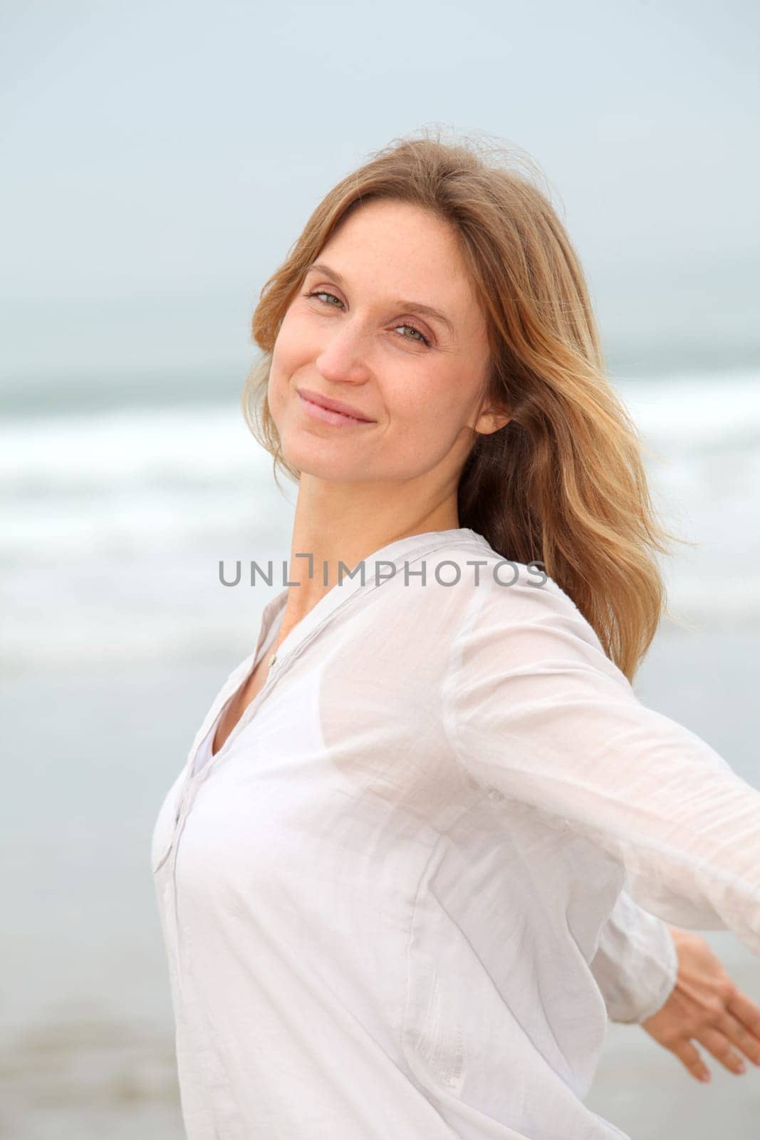 Woman breathing fresh air by the sea