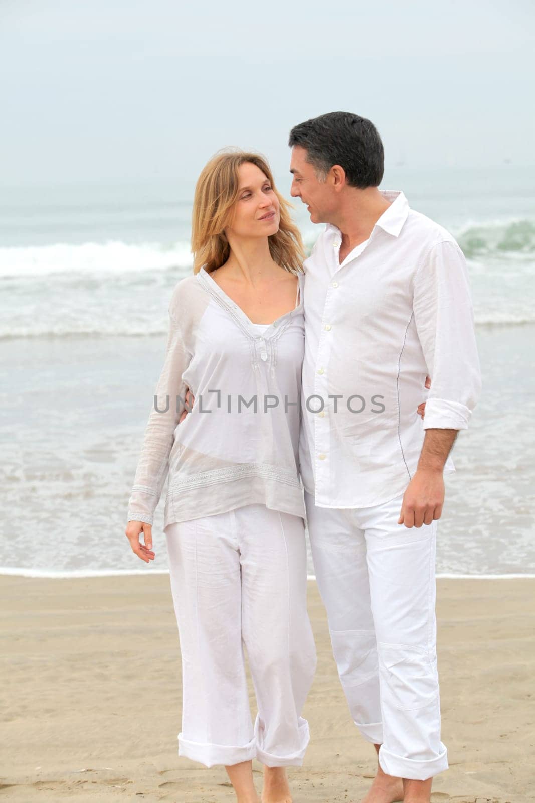 Couple walking by the beach