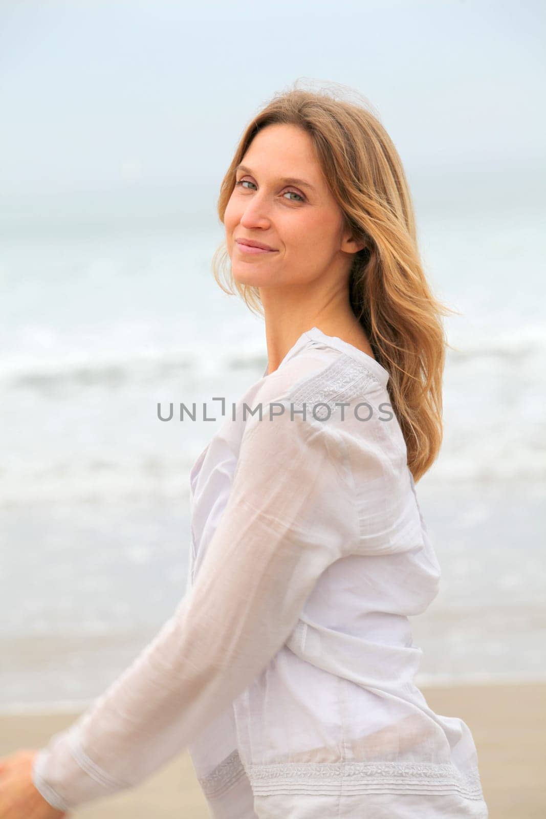 Woman breathing fresh air by the sea