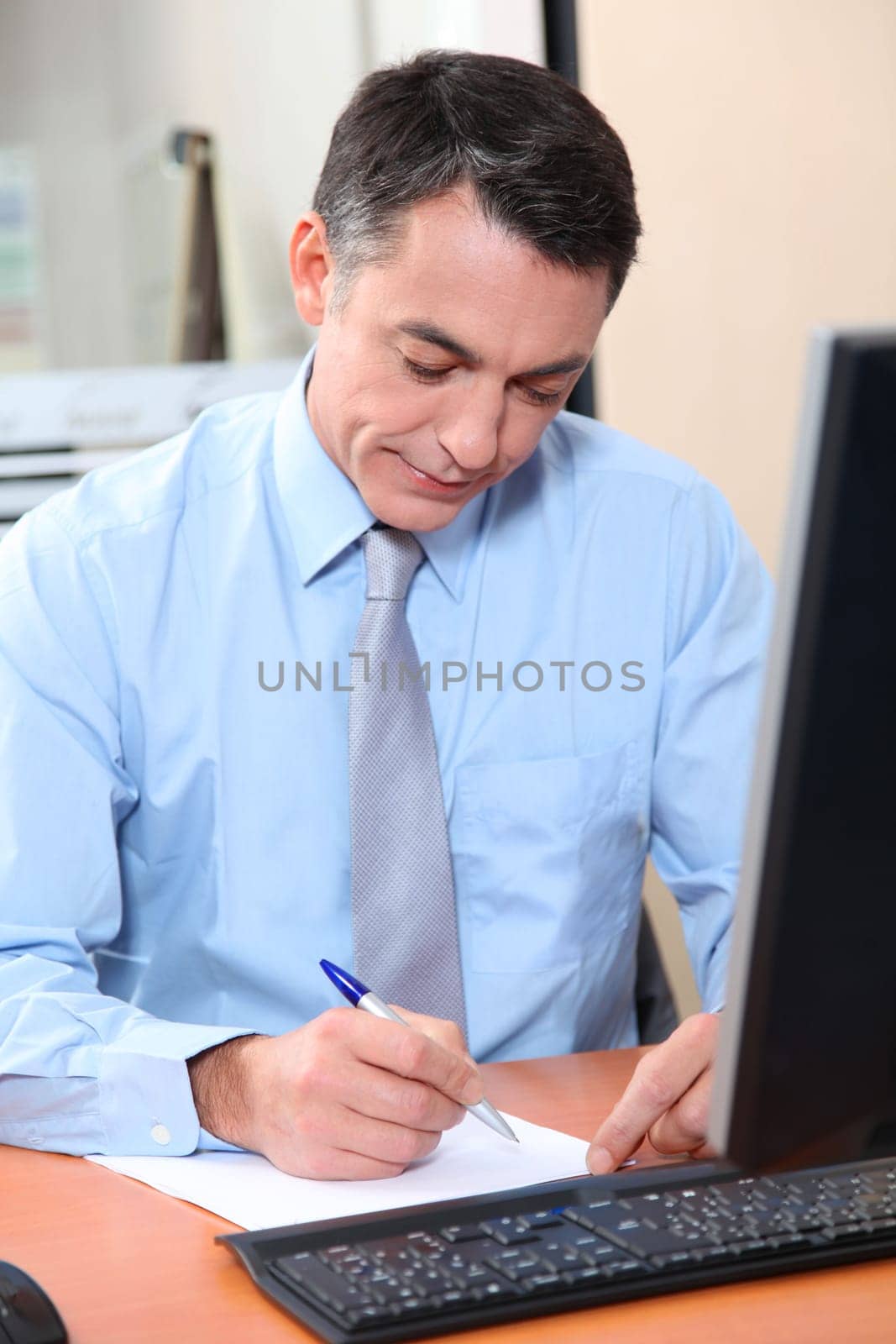Salesman working in front of computer