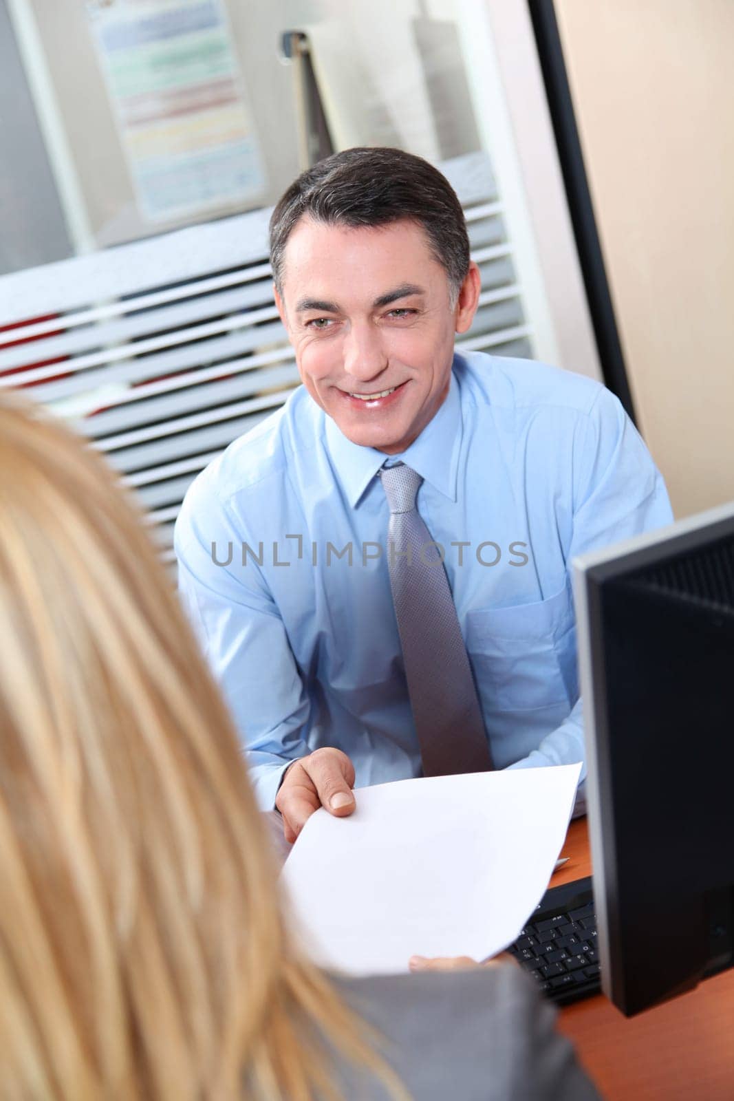 Woman meeting financial adviser in office