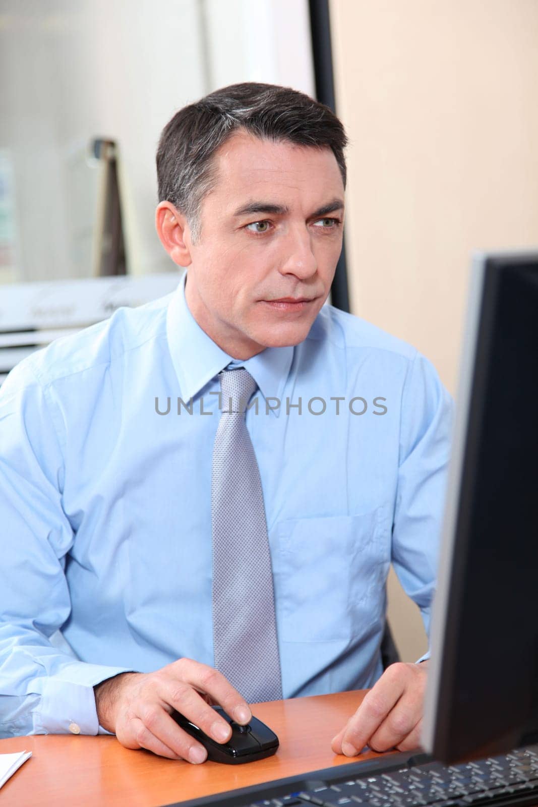 Salesman working in front of computer