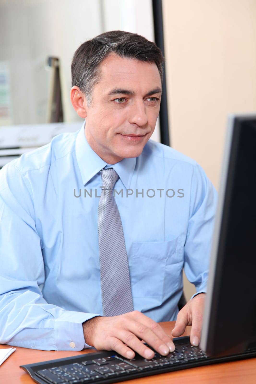 Salesman working in front of computer