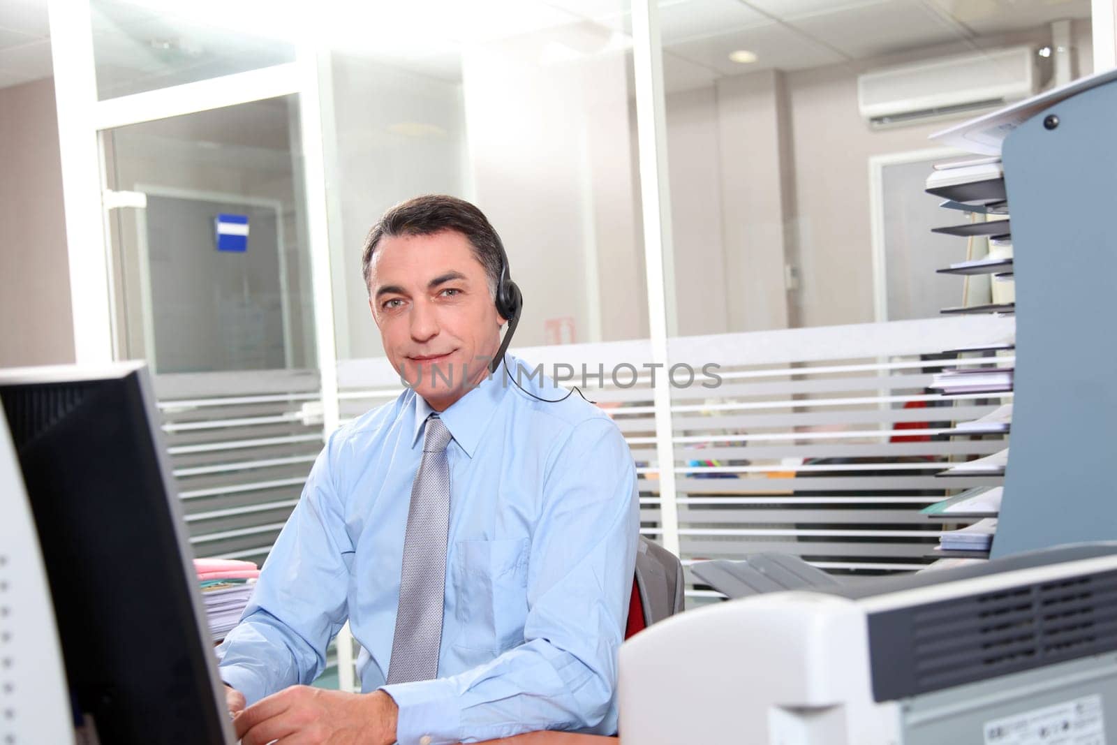 Adult man in the office talking on the phone
