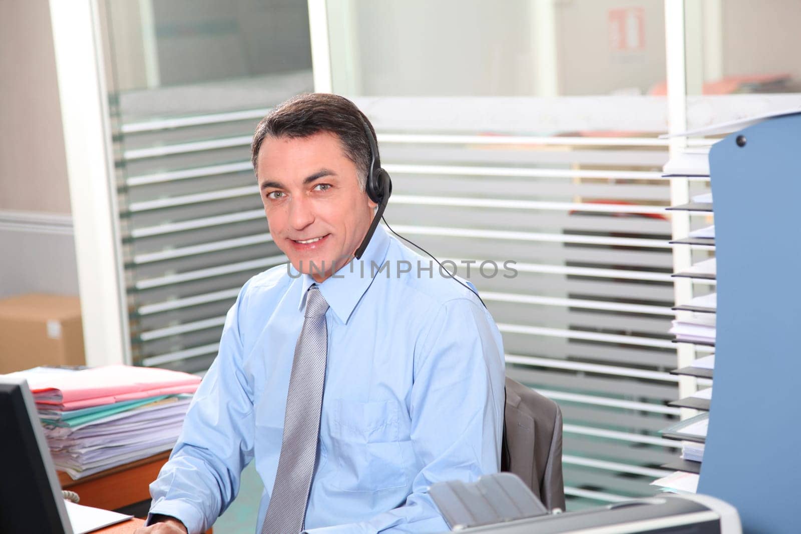Adult man in the office talking on the phone