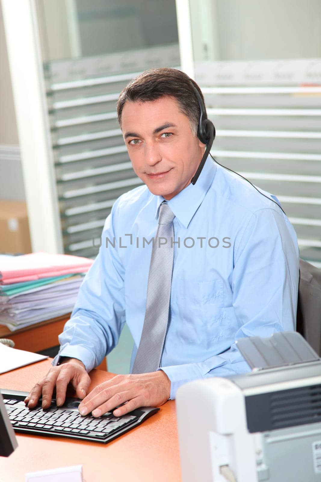 Adult man in the office talking on the phone