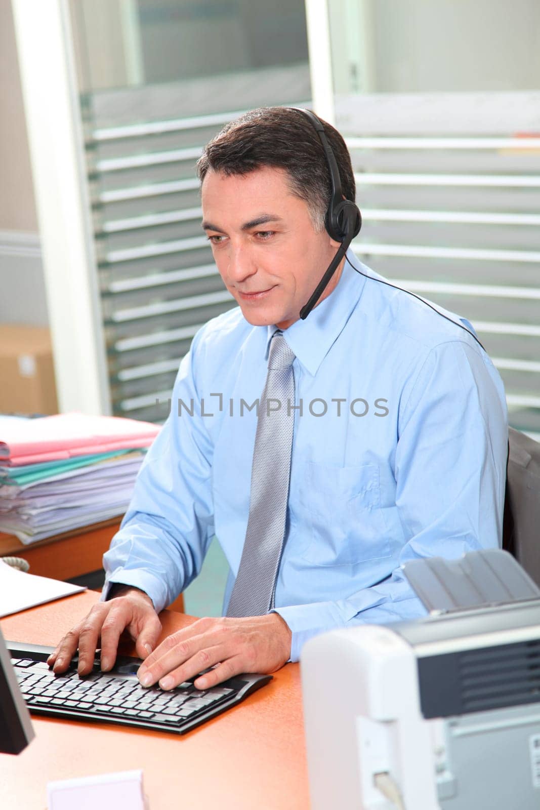 Adult man in the office talking on the phone