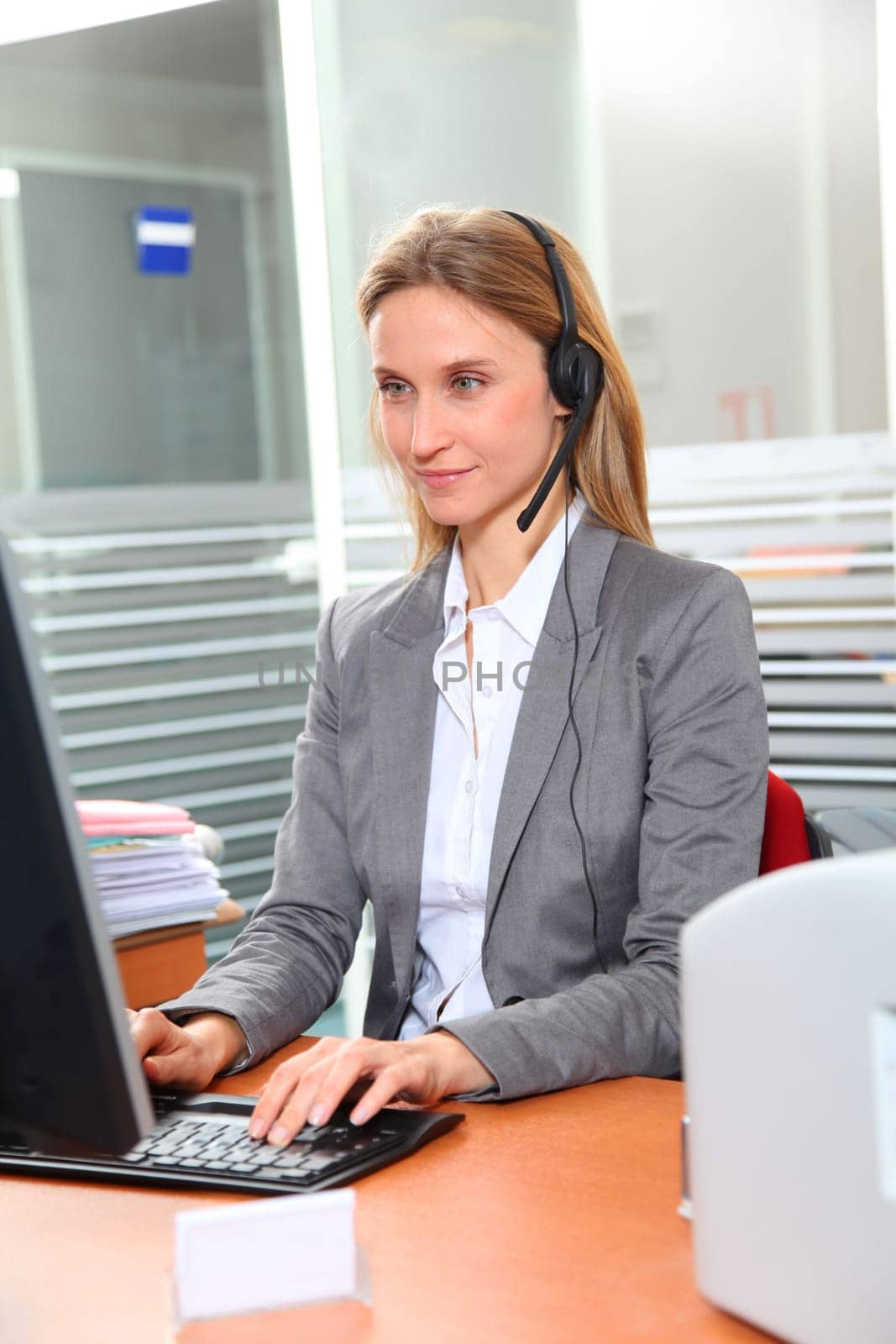 Blond office worker with headphones
